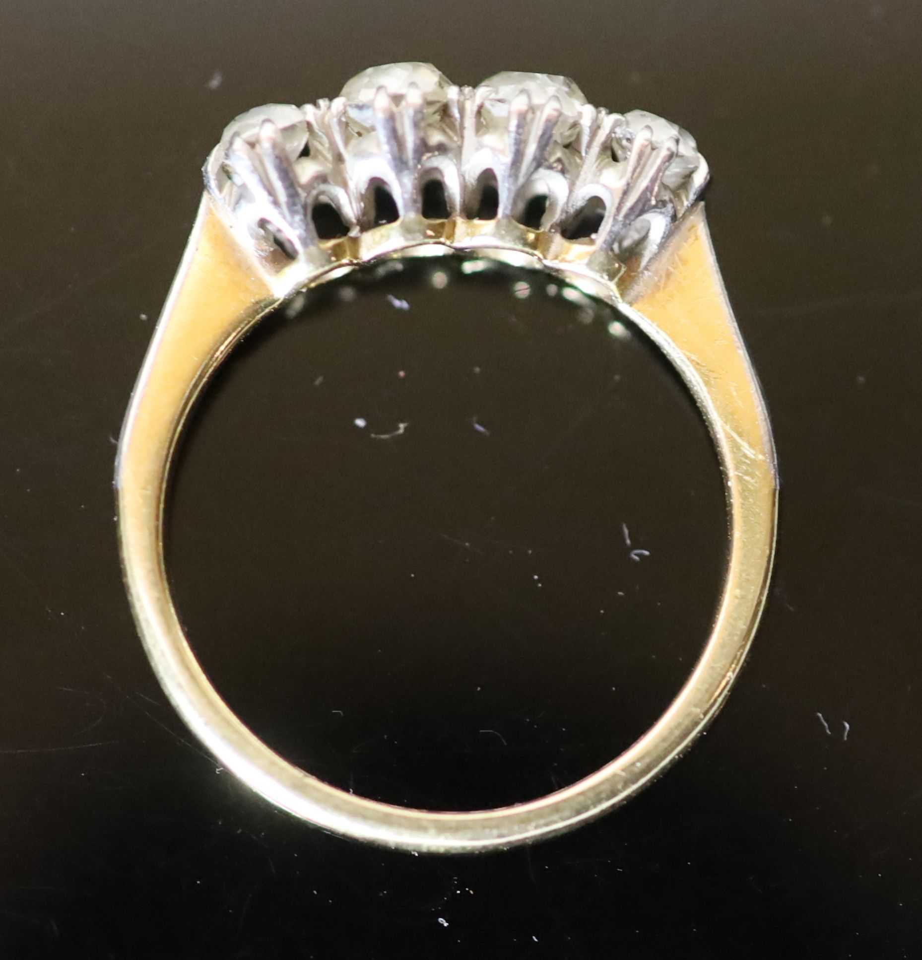 An early 20th century 18ct gold, platinum and graduated four stone diamond ring,